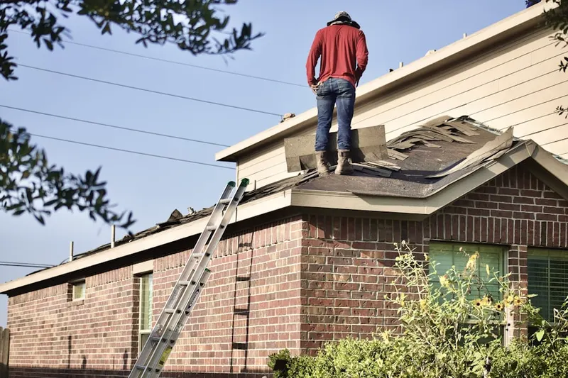 Professional roofer working on a residential roof in Woodbridge